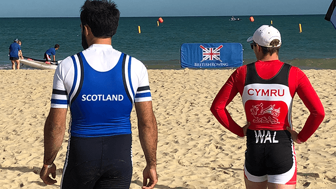 Men wearing Scotland and Wales kit waiting for beach sprint start