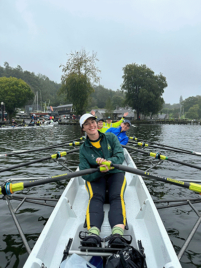 Happy rowers in boat on Windermere