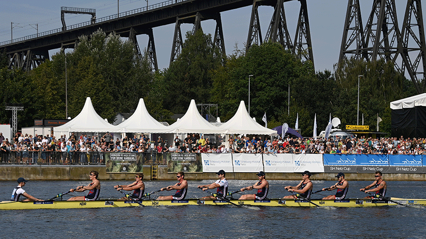 Men's eight approaching high girder bridge