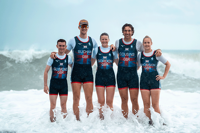 Beach Sprint crew tanding in front of large waves