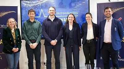 People standing in front of British Rowing Awards display screen