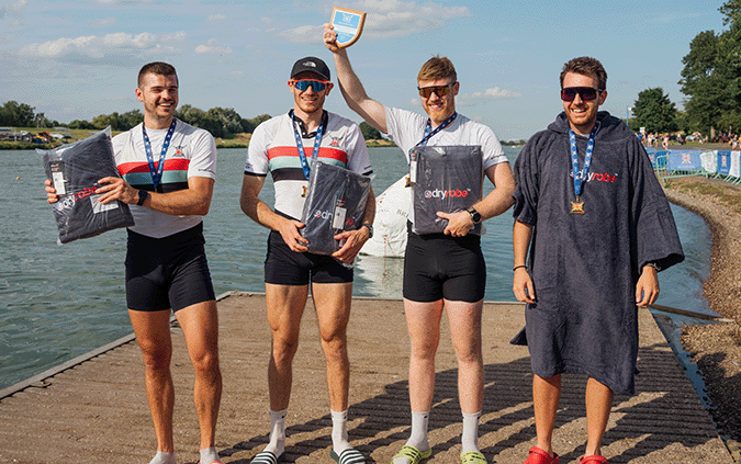 4 men with plaque and medals