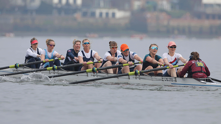 Women's masters eight racing on Tideway